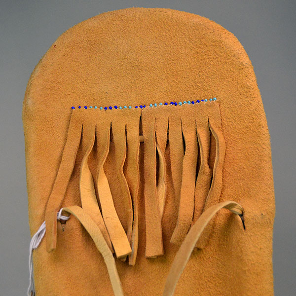 This Vintage Cradleboard- Doll is ready for display in your home! It is in remarkably great condition for its age made in 1988 in Reno Nevada. Pictured here is the fringe on the back.