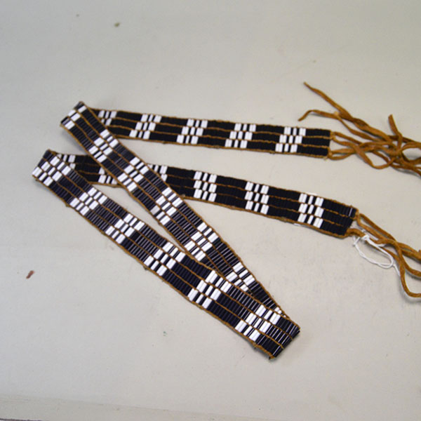 This striking 46.5‑inch Glass Wampum Strap/Belt-3 Row features three rows of white and blue 3×8mm glass beads, arranged in a classic pattern. ONE OF A KIND