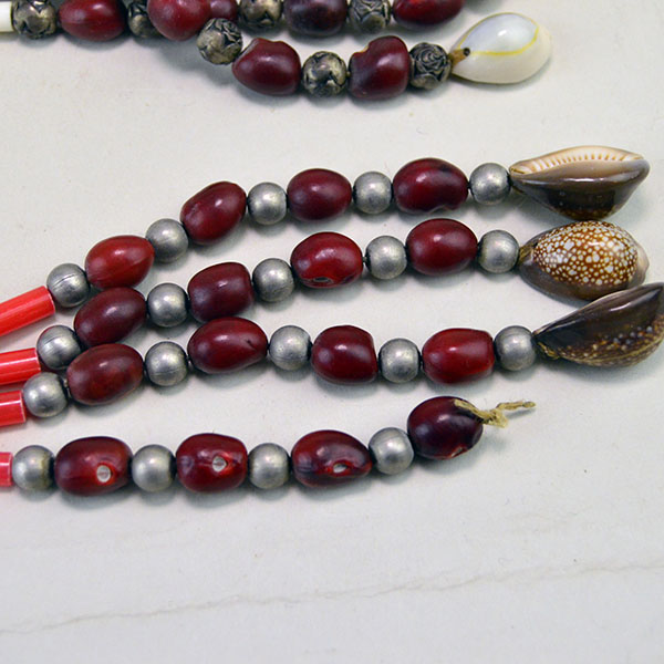 hollow metal beads and matte hollow metal beads. pictured here is the end with the cowrie shells.