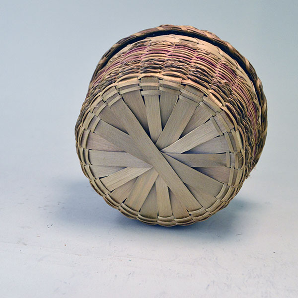 This vintage round Basket- Ash & Sweetgrass Red makes a great addition to any collection. It measures 3.5 inches tall with the cover on. One of a Kind. pictured here is the bottom of the basket.