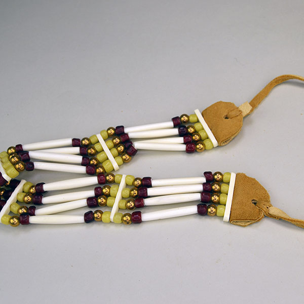 four row No Drop Choker comes with 1.5 inch Bone Hairpipe . This Choker measures 16 inches long with 10‑inch ties. One of a Kind. pictured here is the bone spacers, the beads and the ties.