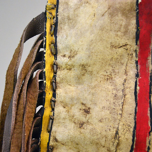 Add this brightly painted Parfleche Bag with Fringe to your collection! The crafter created this small Parfleche from rawhide. One of a Kind. Pictured here is the stitching.