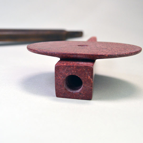 striking centerpiece to your collection with this impressive Peace Pipe- Catlinite Disk. the piece measures a full 22.5 inches. One of a Kind. pictured here is where the stem goes in to the disk.