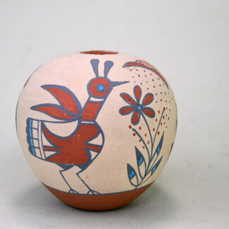 This Pottery- Small Seed Jar showcases a beautifully painted hummingbird, roadrunner, flower, and rain sign. On of a Kind.