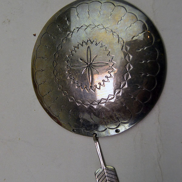 stamped German silver concho with feather dangle