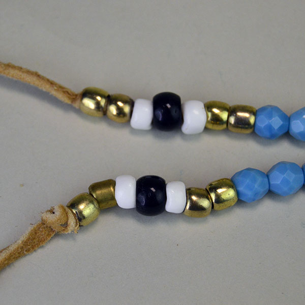 Necklace- Rosette Beaded Thunder Bird and Tipi. 13/0 Cut Seed Beads. Rosette measures approximately 4″ in diameter. One of a Kind. pictured here is the black and white crow beads, old style brass beads, and fire polished beads.