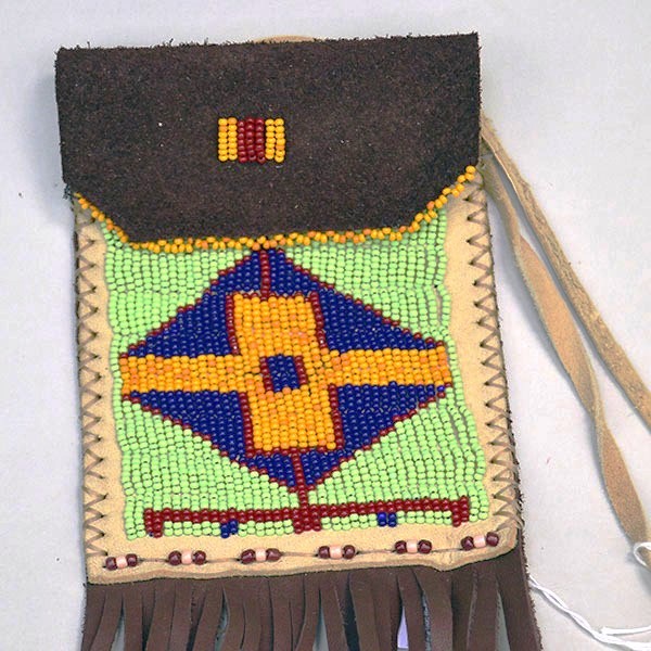 Pouch- Dark Brown Deerskin delivers standout craftsmanship. measures approx. 5″ x 4″. 3″ x 3.25″ beaded panel design on the front. One of a Kind. pictured here is the beaded panel on the tan deerskin.