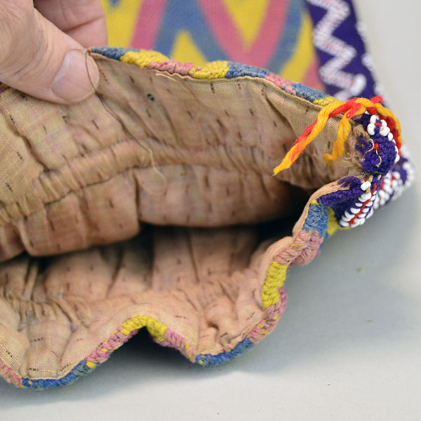 vintage Bag- Wool Yarn Fingerwoven features a soft cotton lining. measures 10" wide by 14" long. few small areas of yarn show age‑related deterioration. pictured here is the cotton lining.