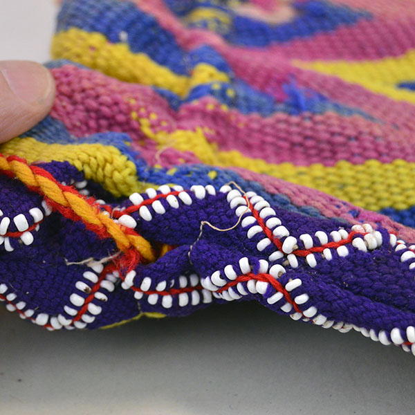 vintage Bag- Wool Yarn Fingerwoven features a soft cotton lining. measures 10" wide by 14" long. few small areas of yarn show age‑related deterioration. pictured here is the bead work down the side, the beads are woven at the same time the back was made.