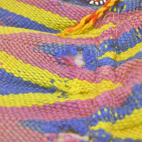 vintage Bag- Wool Yarn Fingerwoven features a soft cotton lining. measures 10" wide by 14" long. few small areas of yarn show age‑related deterioration. Pictured here shows the wool coming apart.