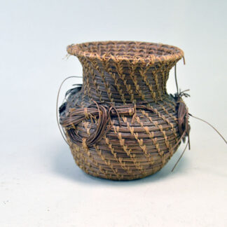 Basket- Pine Needle features decorative needle‑trim accents, natural character of 1970s craftwork. 4.5‑inch top diameter and a 5.25‑inch height.