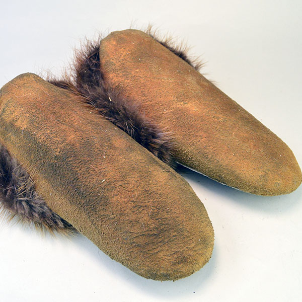 hand‑crafted Cree smoked‑moosehide moccasins showcase classic Cree styling. vibrant floral beadwork design adorns the vamp. beaver fur to the cuffs. pictured here are the soles.