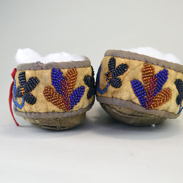 vintage Moccasins- Cree Style Youth in the 1940s to 1950s using brain‑tanned deer hide and a center‑seam construction. Beaded vamp and cuffs. one of a Kind. beaded cuffs on the back.