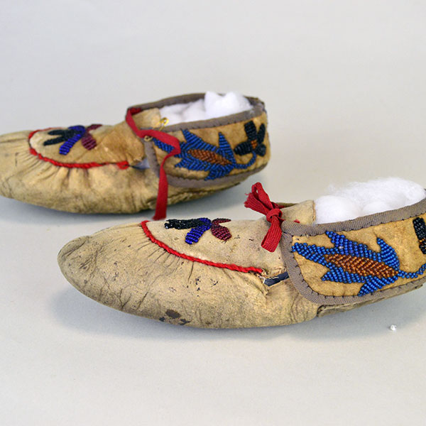 vintage Moccasins- Cree Style Youth in the 1940s to 1950s using brain‑tanned deer hide and a center‑seam construction. Beaded vamp and cuffs. one of a Kind. pictured here you can see the seam has come unstitched.