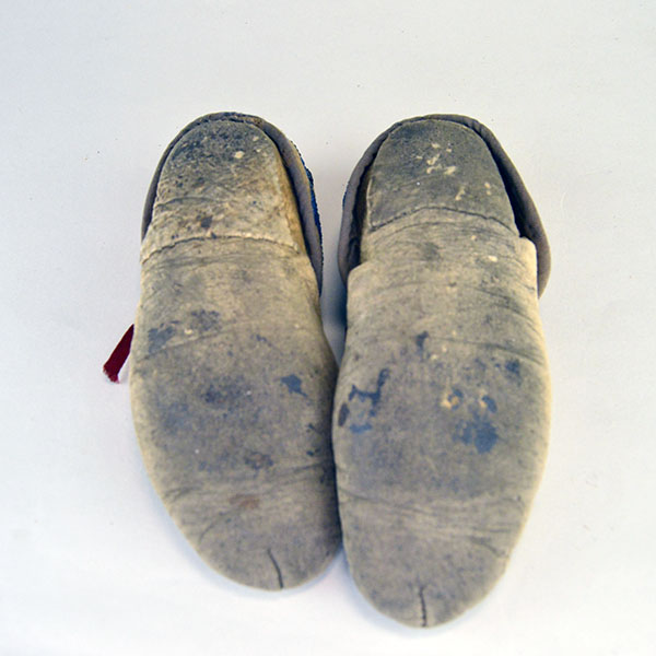 vintage Moccasins- Cree Style Youth in the 1940s to 1950s using brain‑tanned deer hide and a center‑seam construction. Beaded vamp and cuffs. one of a Kind. the soles.