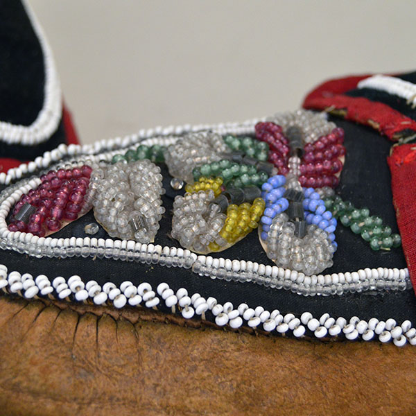 Early 20th Century Moccasins- Iroquois Style Antique to your collection. raised Floral beadwork design to the vamps. some of the stitching has come apart. bead work on the vamp.