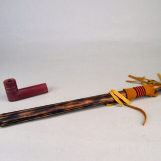 Pipe- Catlinite with Stem an impressive addition to your collection. complete pipe measures 21 inches overall. This pipe has been used. one of a kind.