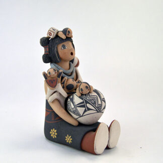 This striking Pottery- Pueblo Storyteller. Standing 6 inches tall, bowl rests on her lap as four lively children gather around her. One of a Kind.