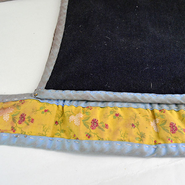 Bag- Wool Shoulder Beaded features beadwork and hand‑sewn ribbon edging. measures approx. 8.5" tall x 9" wide, shoulder strap measures 29" long. the floral fabric on the back of the strap.