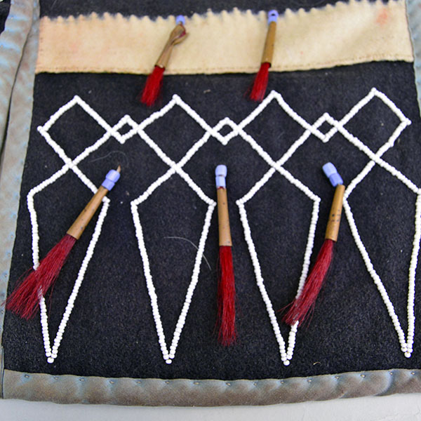 Bag- Wool Shoulder Beaded features beadwork and hand‑sewn ribbon edging. measures approx. 8.5" tall x 9" wide, shoulder strap measures 29" long. The front of the of the bag.