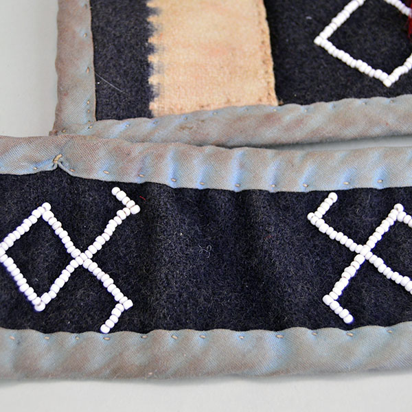 Bag- Wool Shoulder Beaded features beadwork and hand‑sewn ribbon edging. measures approx. 8.5" tall x 9" wide, shoulder strap measures 29" long. The beadwork design on the strap.