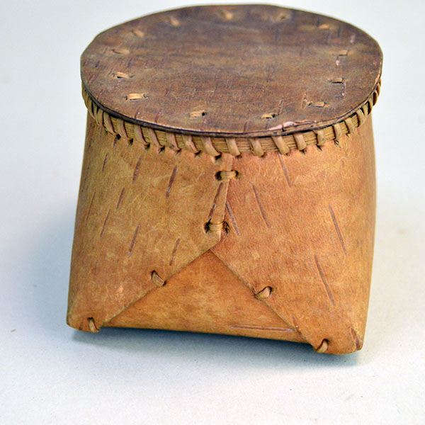 1950's tiny Basket- Birchbark with Lid. artist secured the container with traditional spruce‑root stitching. approx. 2.75" tall x 3.5" long. one of a kind. the other side