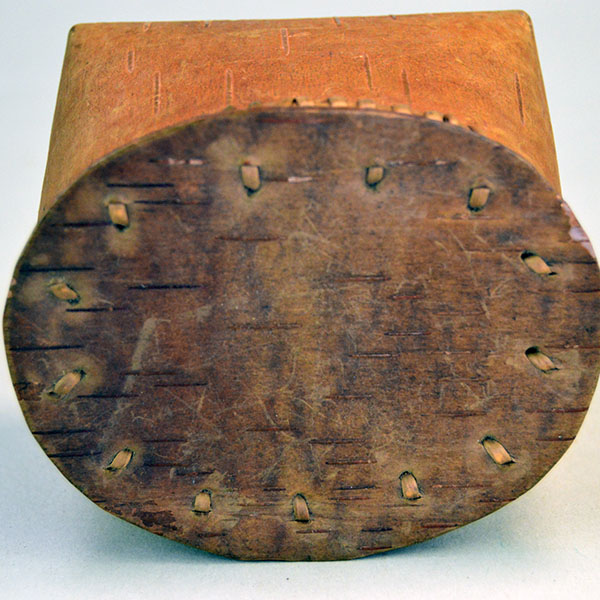 1950's tiny Basket- Birchbark with Lid. artist secured the container with traditional spruce‑root stitching. approx. 2.75" tall x 3.5" long. one of a kind. the outside of the lid.