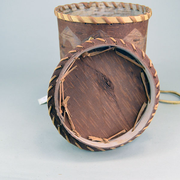 Floral‑Etched Birchbark Basket with Lid Container features Floral etchings around the container and the cover. approx. 19" tall x 8" in diameter. The inside of the cover.