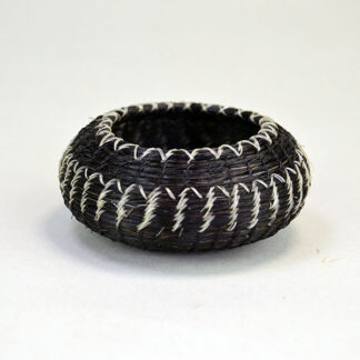 This contemporary horsehair basket delivers striking craftsmanship. Measures Approx. 3‑inch diameter and 1¼‑inch height. One of a Kind.