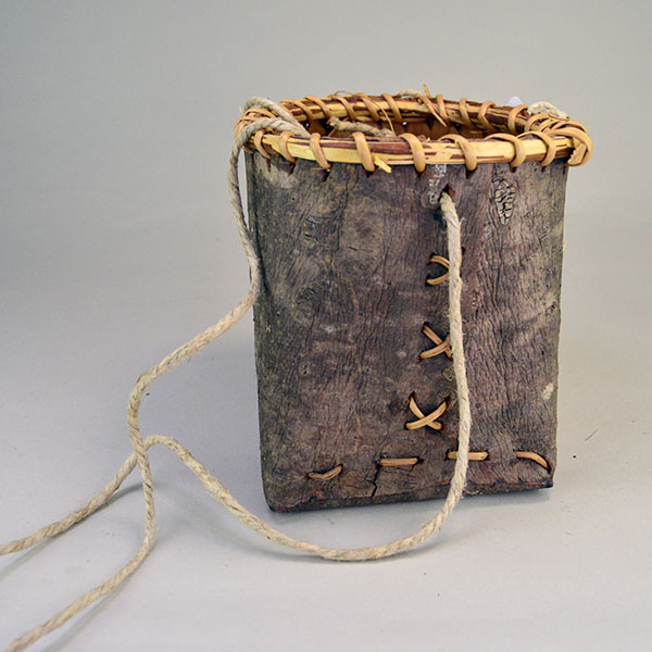 crafter Jennifer Lee created this striking Basket- Pine Bark container. approx. 6" tall with an 6" opening, the bottom is approx. 7" wide. One of a kind. The side of the container.