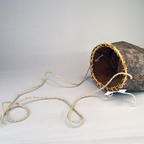 crafter Jennifer Lee created this striking Basket- Pine Bark container. approx. 6" tall with an 6" opening, the bottom is approx. 7" wide. One of a kind. The long hemp cord strap.