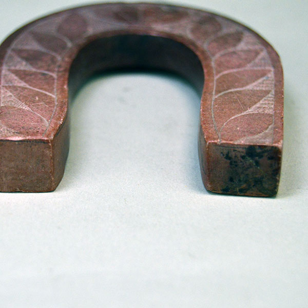 hand carved Catlinite horseshoe features hand‑etched designs on both sides. measures approximately 3.5 inches tall and 2.75 inches wide. One of a Kind. The ends.