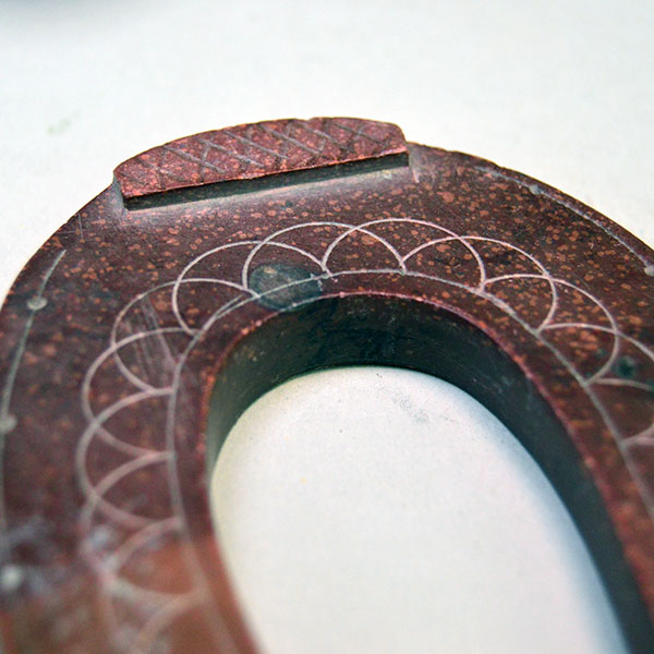 hand carved Catlinite horseshoe features hand‑etched designs on both sides. measures approximately 3.5 inches tall and 2.75 inches wide. One of a Kind.