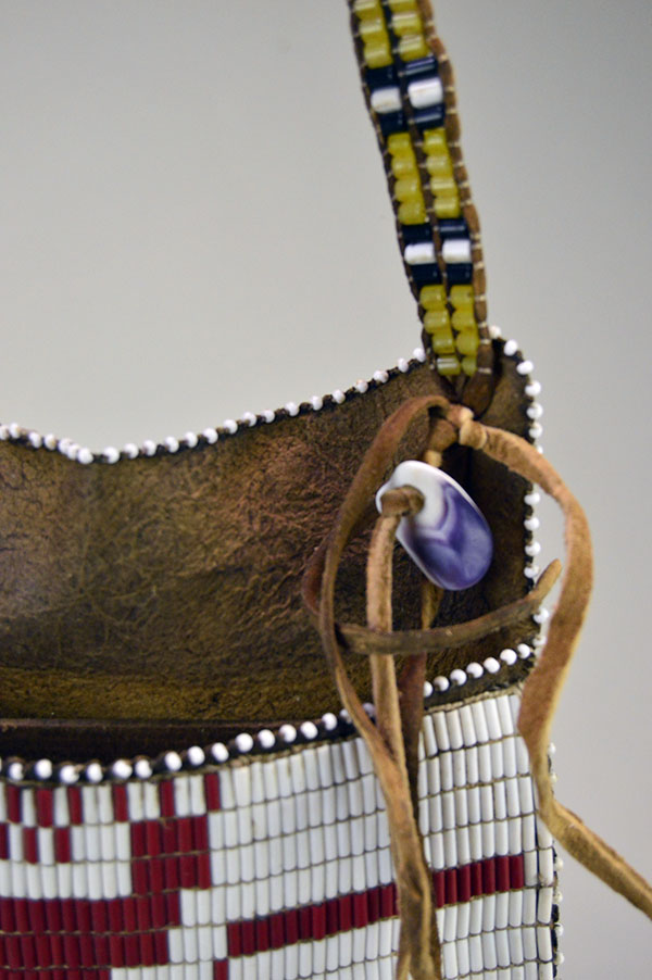 Hunting Bag Underwater Panther Design is constructed from walnut‑dyed Braintanned. measures approximately 8 by 7.5 inches. One of a Kind. the wampum shell attached to the strap.