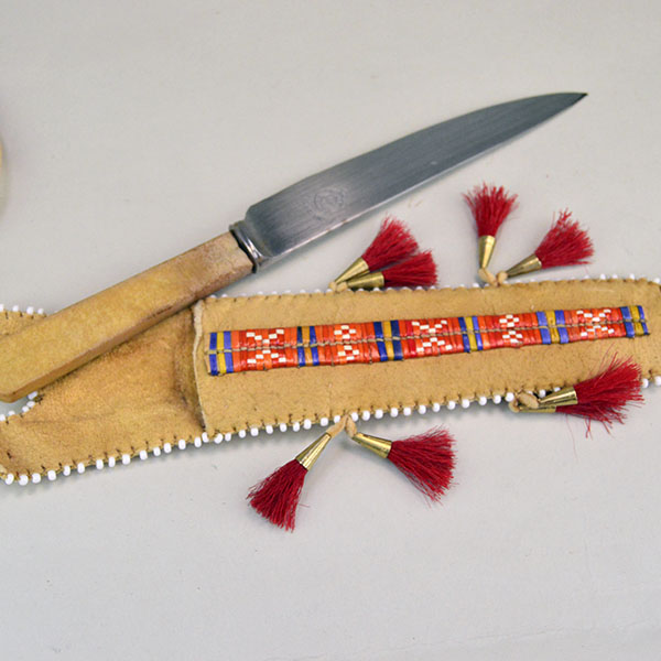 Knife- Braintanned Sheath Quilled set showcases bold color, traditional materials. The front showcases a vivid quilled design. With Knife. approx 12 inches. the knife and the sheath.