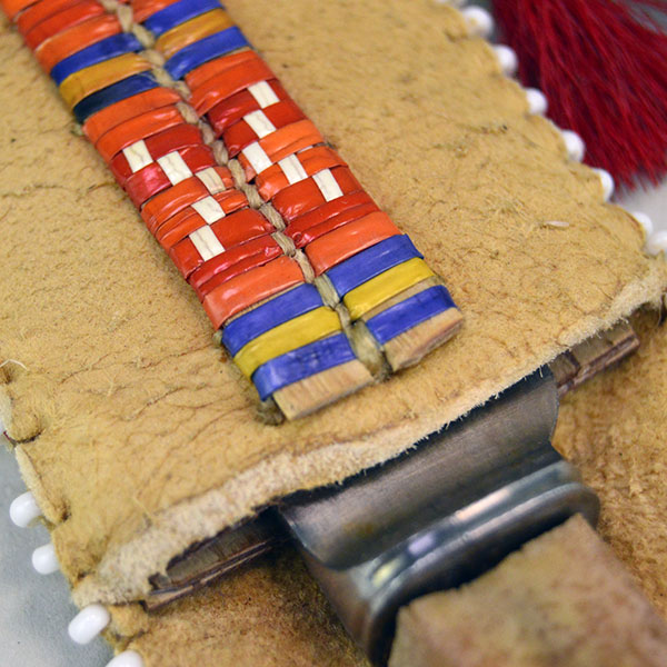 Knife- Braintanned Sheath Quilled set showcases bold color, traditional materials. The front showcases a vivid quilled design. With Knife. approx 12 inches. the top where the knife enters.