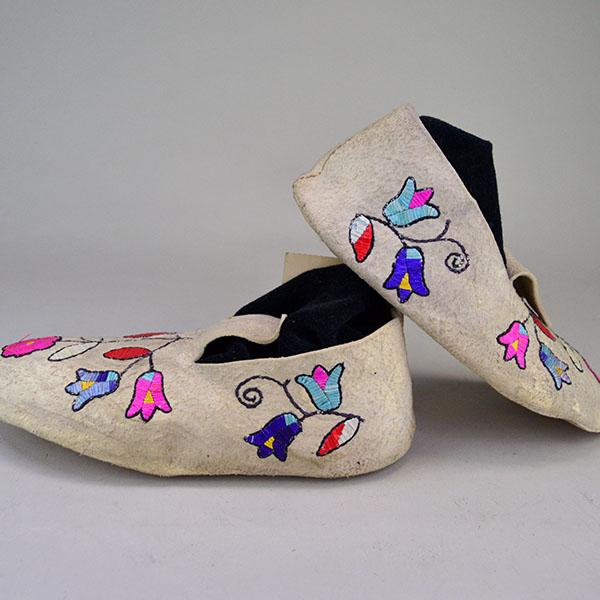 Vintage Moccasin- Floral Quilled showcase a floral quillwork design on Braintanned deerskin, rawhide soles. approx. women's size 8. One of a Kind. The quill floral design on the sides of the moccasins.