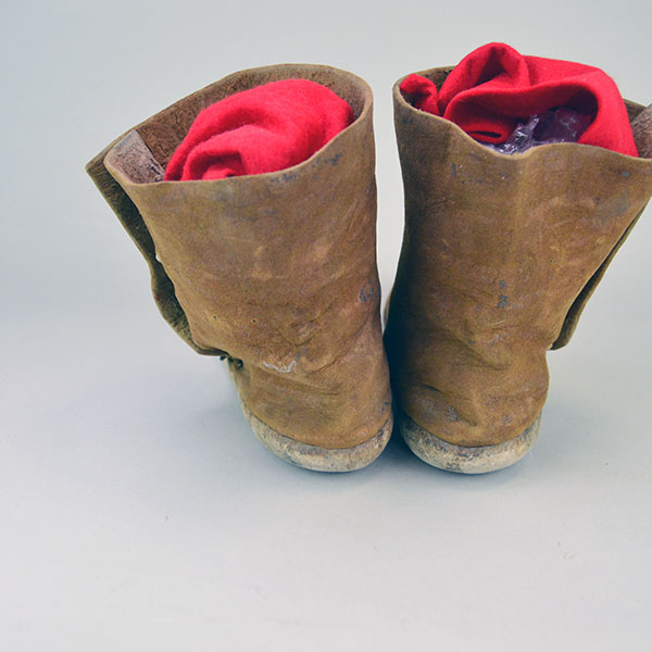 Antique Moccasin- Navajo Style High Boots feature hard rawhide soles, hand‑stitched Braintanned deer hide. Approx. 9.5" l x 3"w x 6.5" h. one of a kind. The back of the boots.