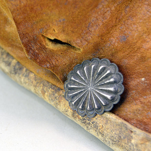 Antique Moccasin- Navajo Style High Boots feature hard rawhide soles, hand‑stitched Braintanned deer hide. Approx. 9.5" l x 3"w x 6.5" h. one of a kind. one of a hand stamped stamped conchos.