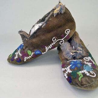 Antique Cree‑style moccasins showcase classic Cree design. Vibrant floral beadwork design, some bead loss. Fur to the cuffs, one missing. women's 8.5.