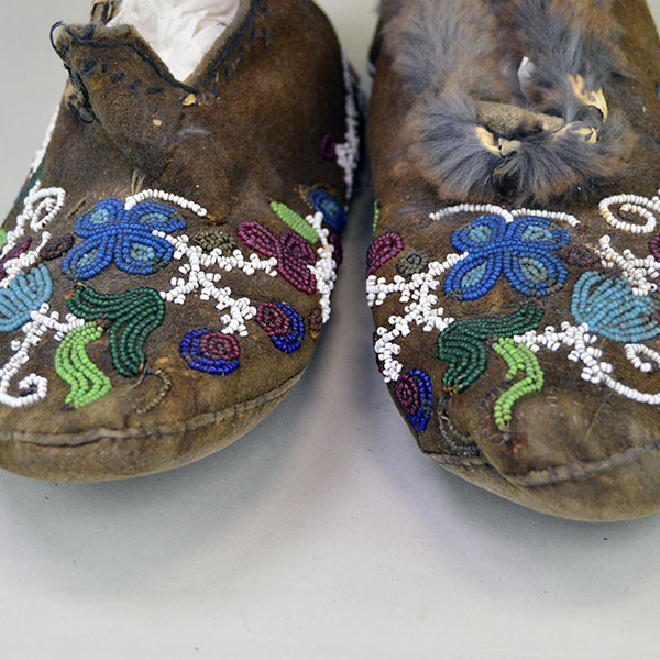 Antique Cree‑style moccasins showcase classic Cree design. Vibrant floral beadwork design, some bead loss. Fur to the cuffs, one missing. women's 8.5. Pictured here is the beadwork.
