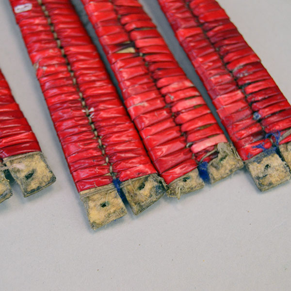 antique set of four Ornament- Quilled Tipi features vivid red‑dyed quills. Each piece measures approx. 5 inches long and 3/4 inch wide at its widest point. a close up of the ends.