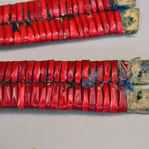 antique set of four Ornament- Quilled Tipi features vivid red‑dyed quills. Each piece measures approx. 5 inches long and 3/4 inch wide at its widest point. pictured here is the backside.
