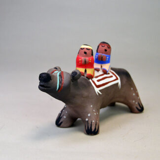 Pottery- Bear Storyteller Figurine features a bear accompanied by two children. approximately 6.5 inches long by 3.75 inches tall. one of a kind.