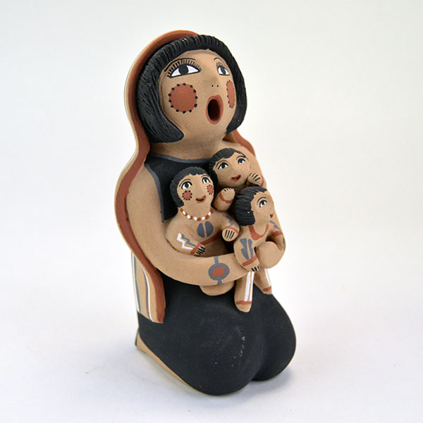 Pottery- Storyteller Pueblo presents a striking, expressive pose that captures the viewer’s attention. Signed base ‘EF Tsosie , Jemez. approx. 6.5" tall.