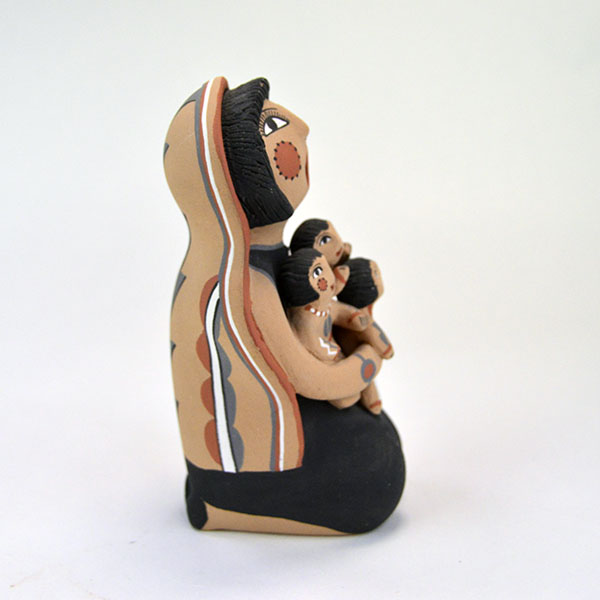 Pottery- Storyteller Pueblo presents a striking, expressive pose that captures the viewer’s attention. Signed base ‘EF Tsosie , Jemez. approx. 6.5" tall. The side view
