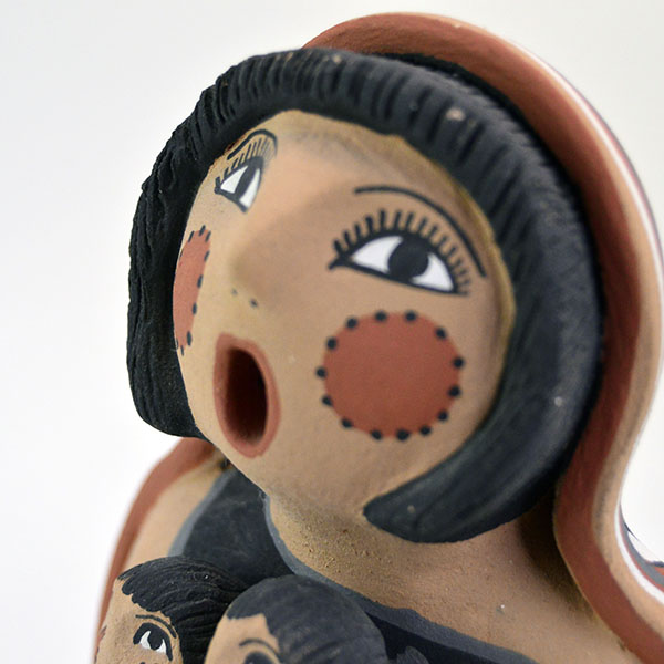 Pottery- Storyteller Pueblo presents a striking, expressive pose that captures the viewer’s attention. Signed base ‘EF Tsosie , Jemez. approx. 6.5" tall. the storytellers face.