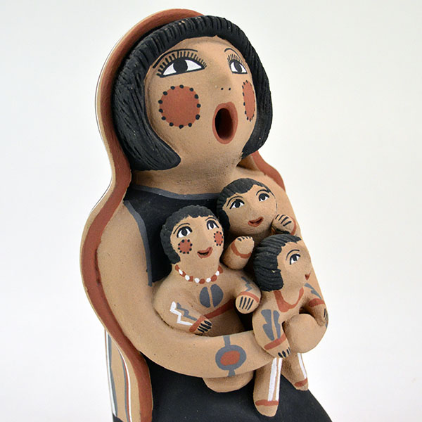 Pottery- Storyteller Pueblo presents a striking, expressive pose that captures the viewer’s attention. Signed base ‘EF Tsosie , Jemez. approx. 6.5" tall. storyteller and three children