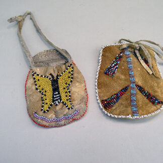 Bag- Beaded Braintanned Pair, dating to the 1940s, showcases two distinct expressions of hand‑worked artistry. Approx. 4.25" x 3.5", and 3" x 3.5".