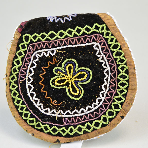 antique, late 1800s Mi'kmaq-style bag, measures approx. 4" x 4". It features a design using 16/0 seed beads intricately stitched onto black velvet. Showing some of the missing beads on the back.